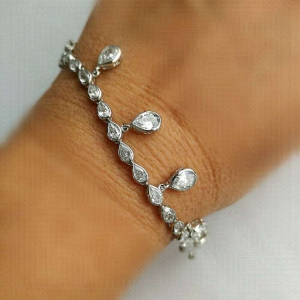 White sapphire tennis bracelet with teardrop charms 14k white gold